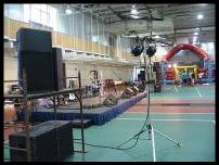 Quinnipiac University Gymnasium decked out for a rainy Spring Weekend concert with games in background